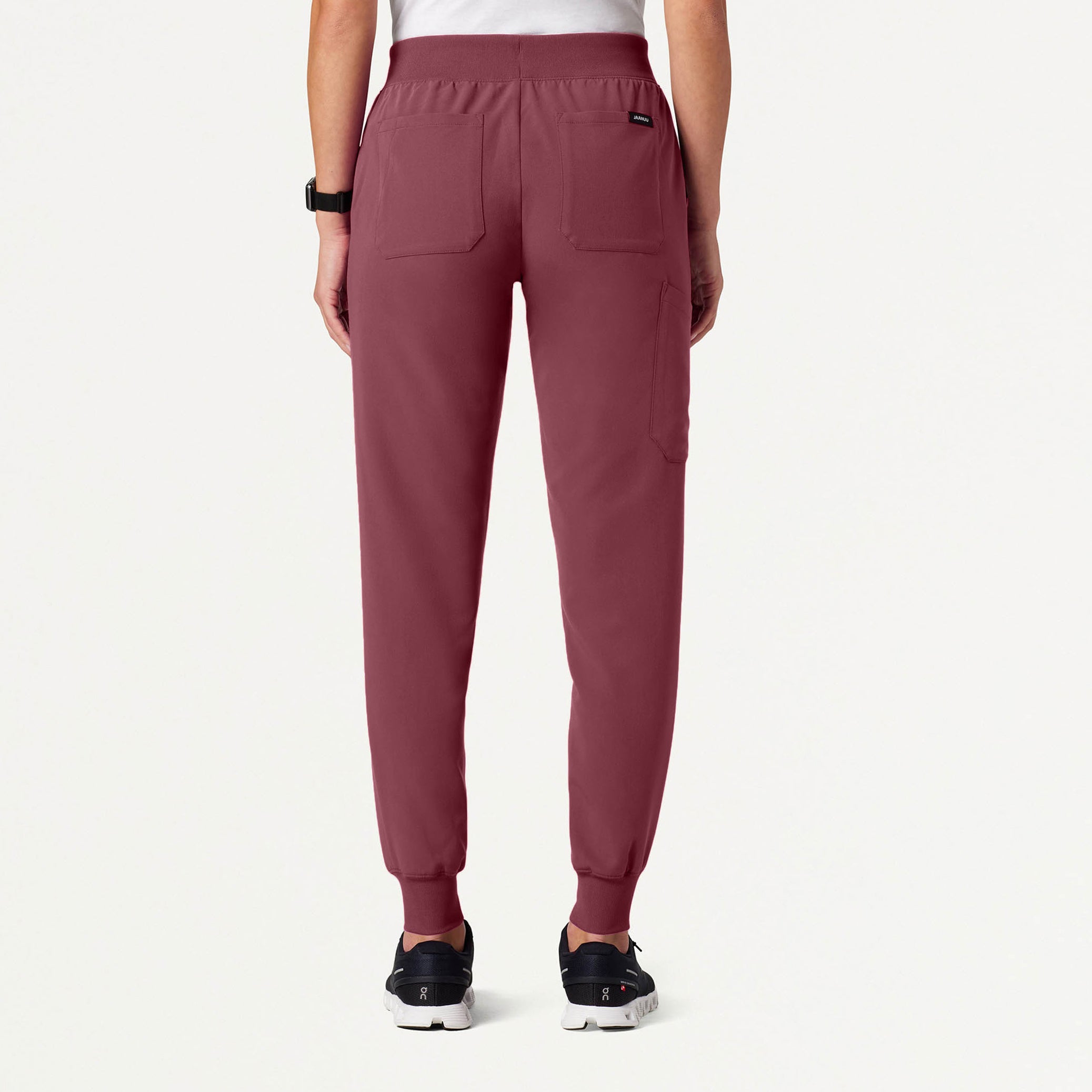 Rosewood jogger pants worn by a person on a white background