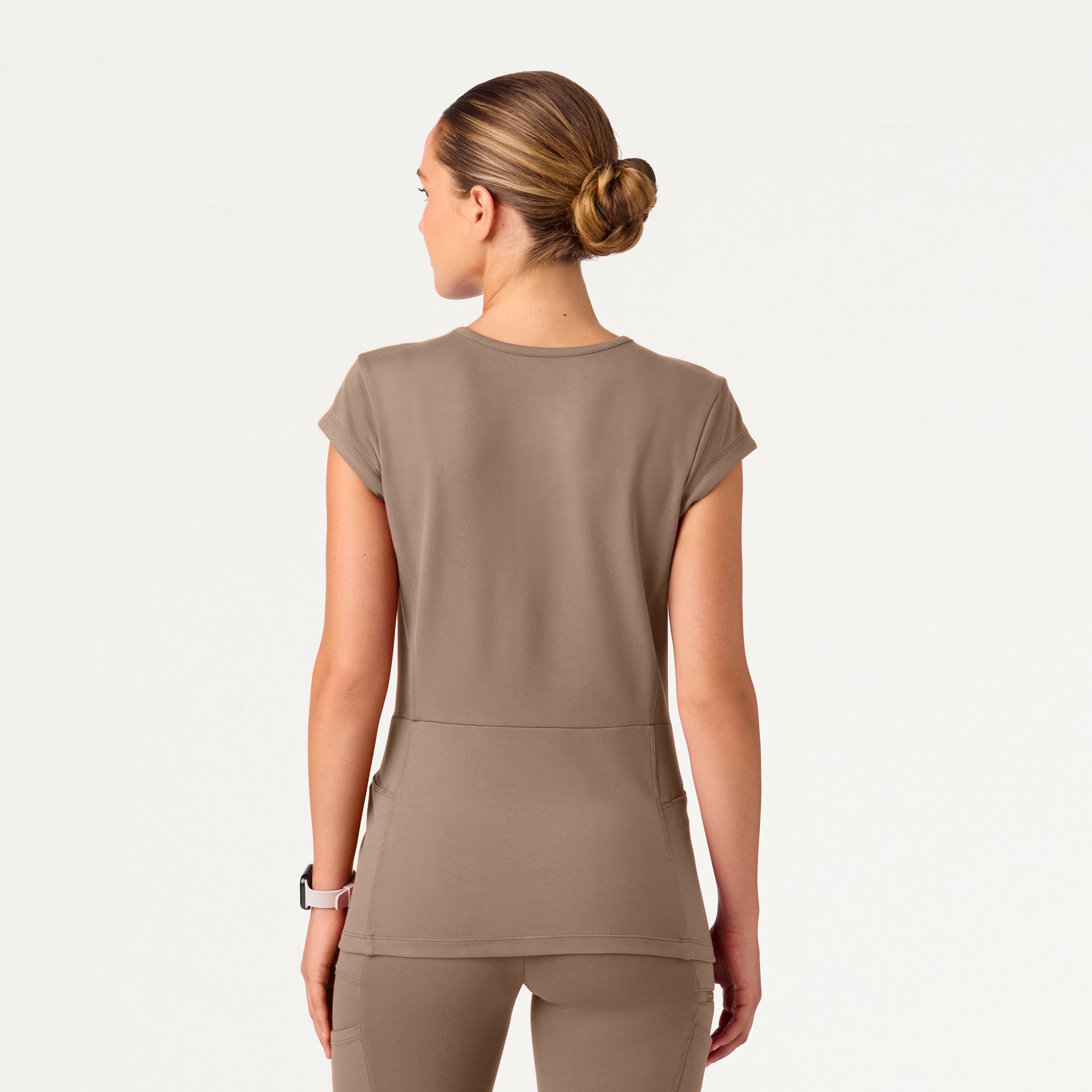 A woman wearing a Mocha scrub top