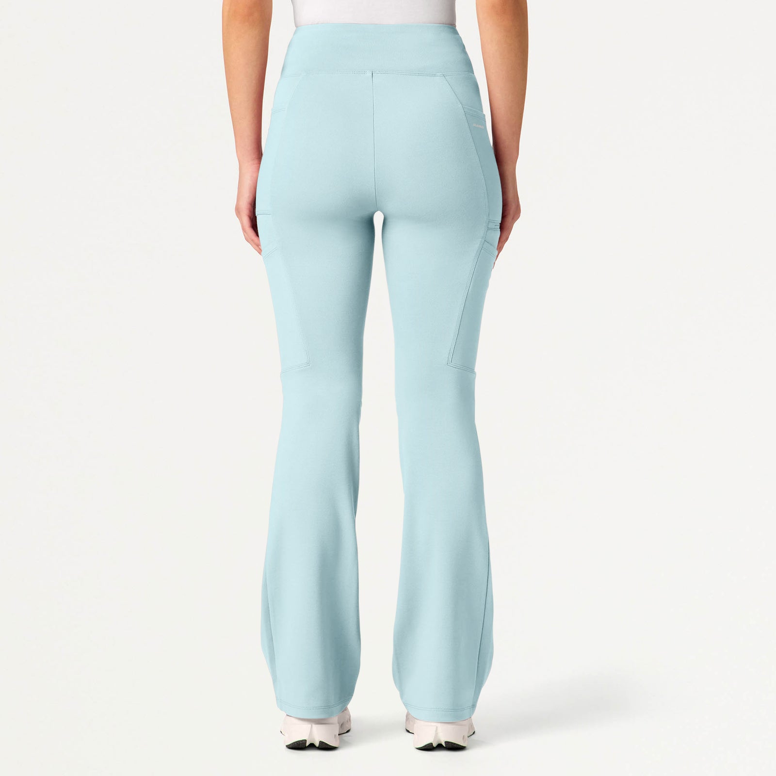 Sky blue scrub pants worn by a woman on a white background