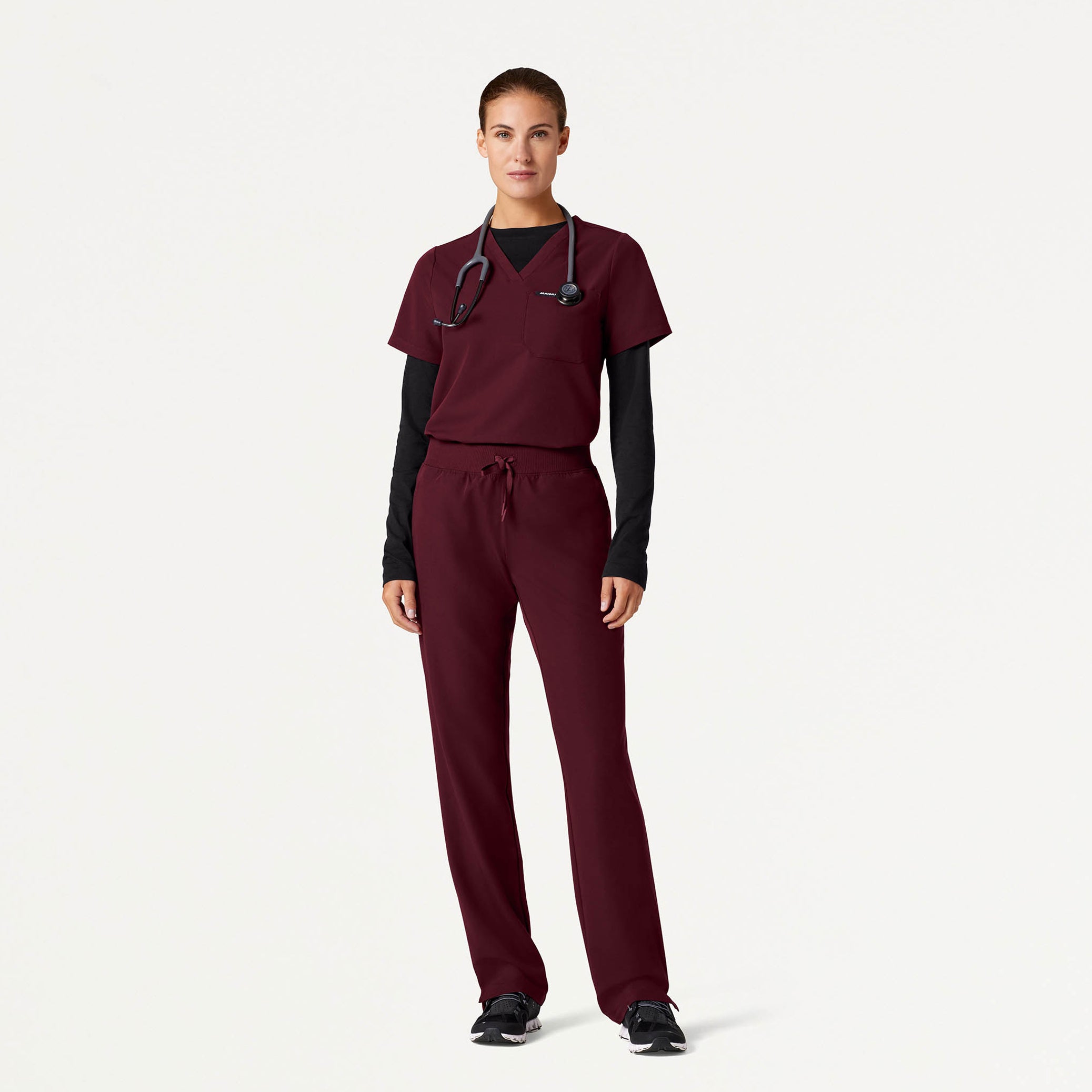Woman wearing Burgundy scrubs with Black underscrub