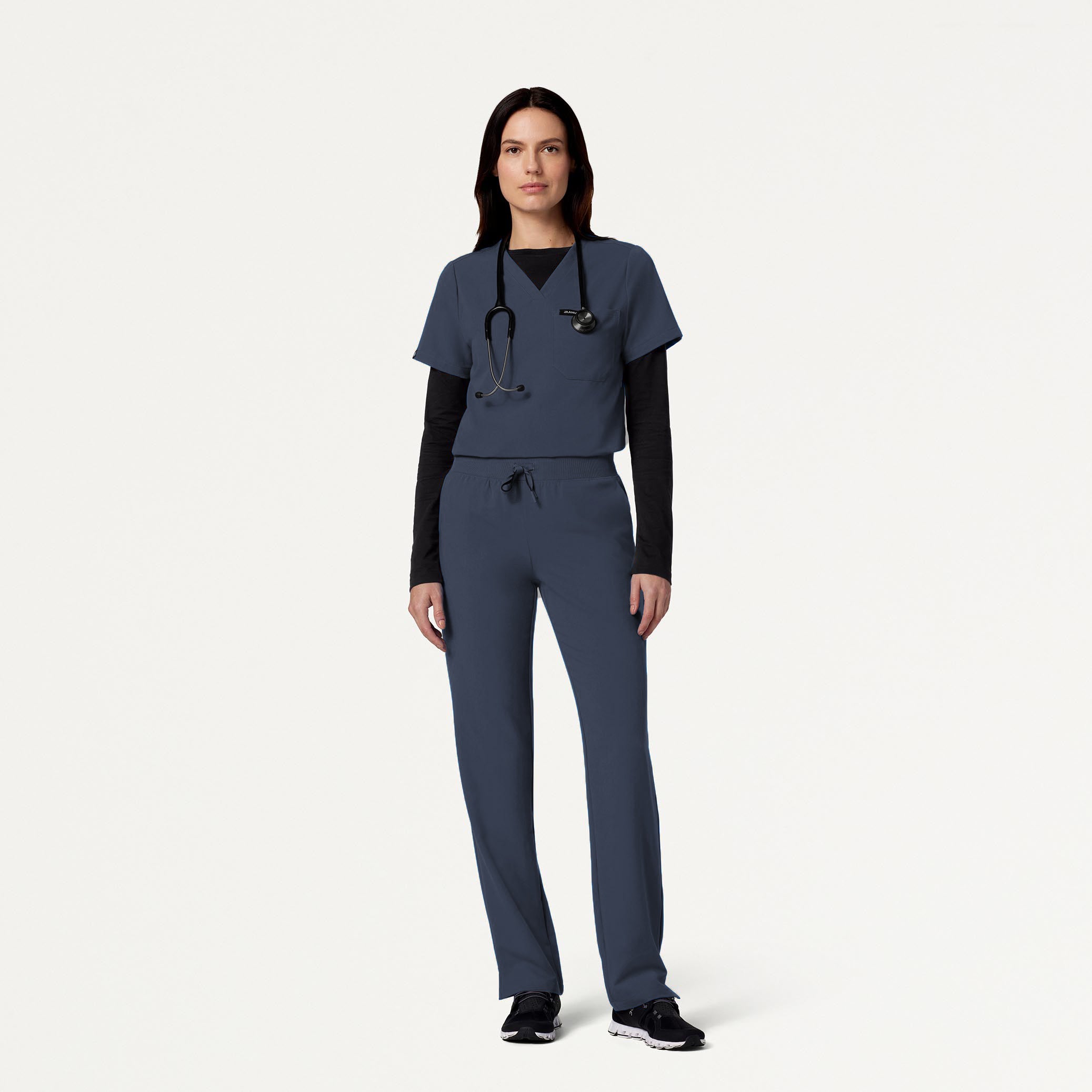 Woman wearing Carbon Gray scrubs with Black underscrub