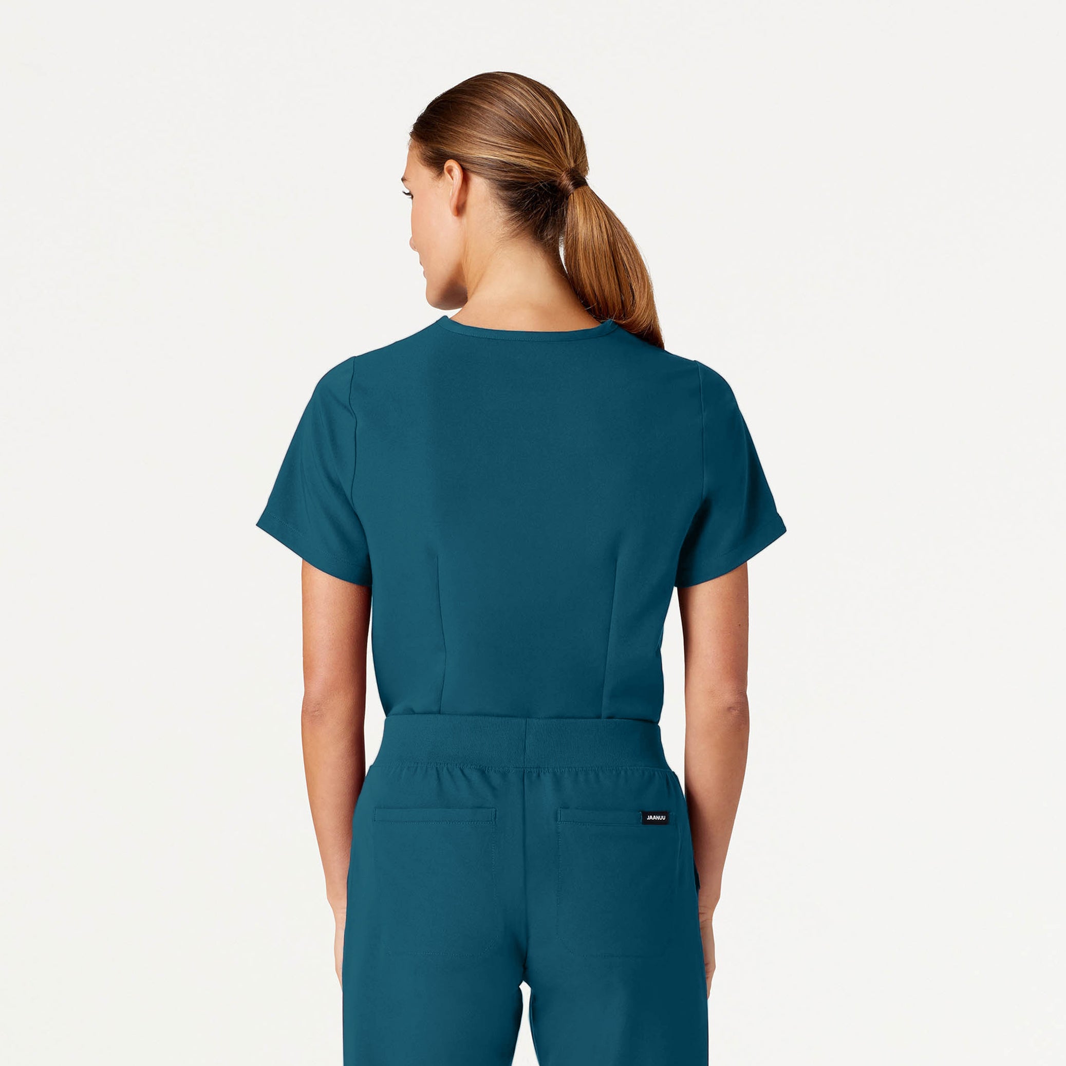 Woman wearing Caribbean Blue scrubs