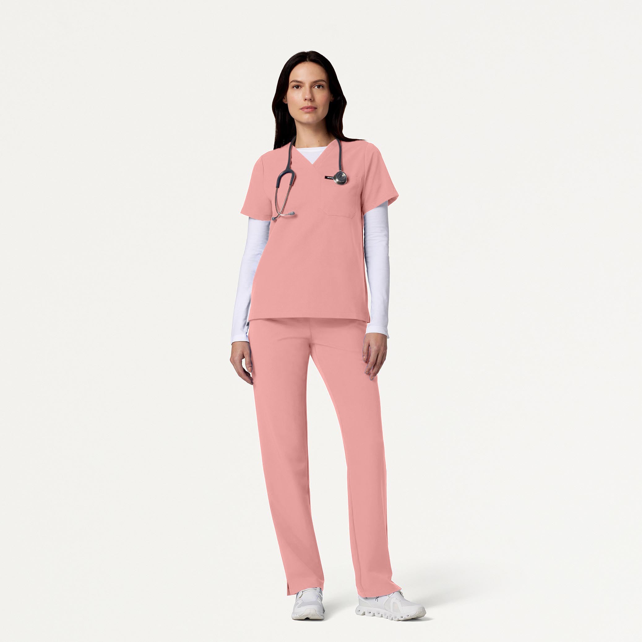 Woman wearing Mauve scrubs with White underscrub