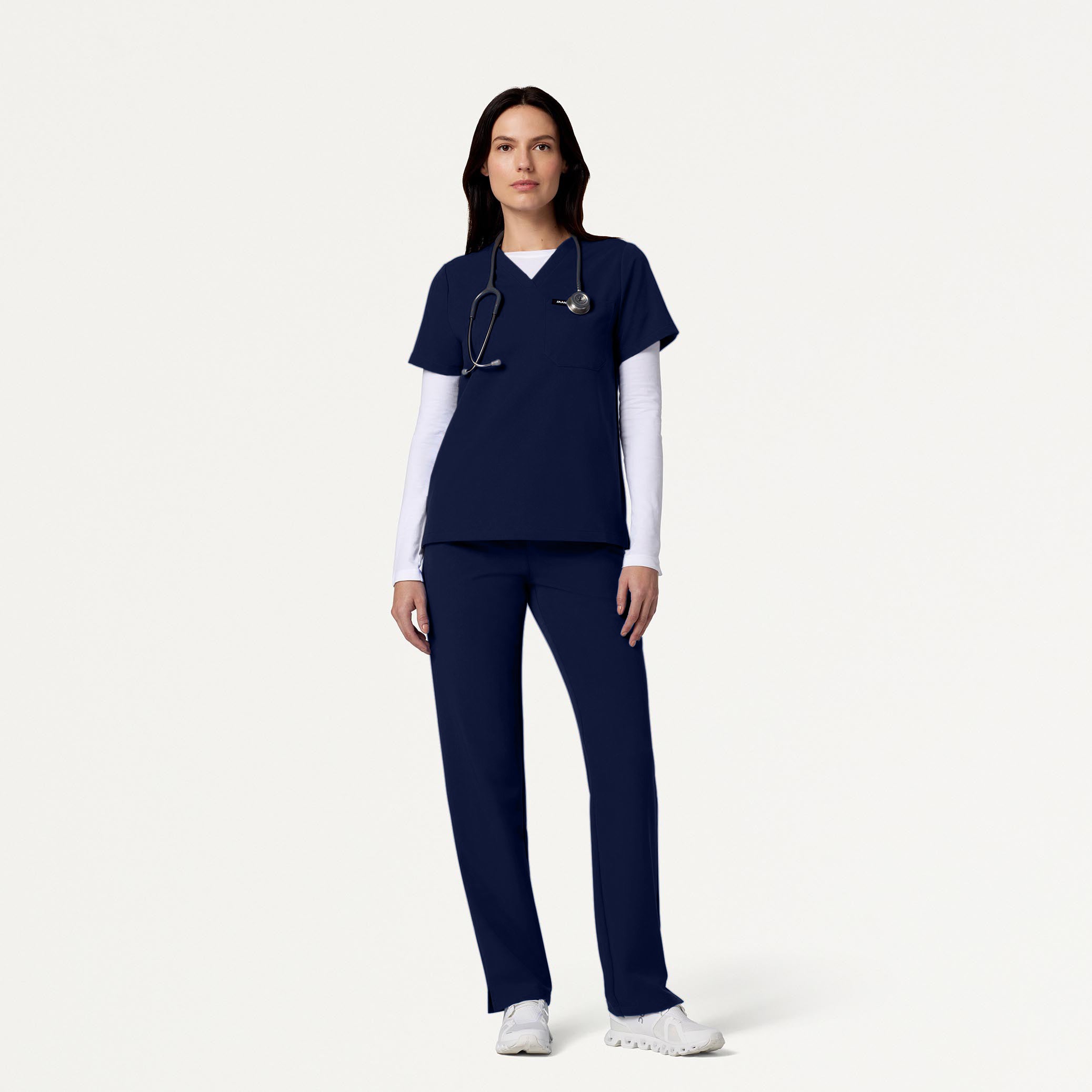 Woman wearing Midnight Navy scrubs with underscrub