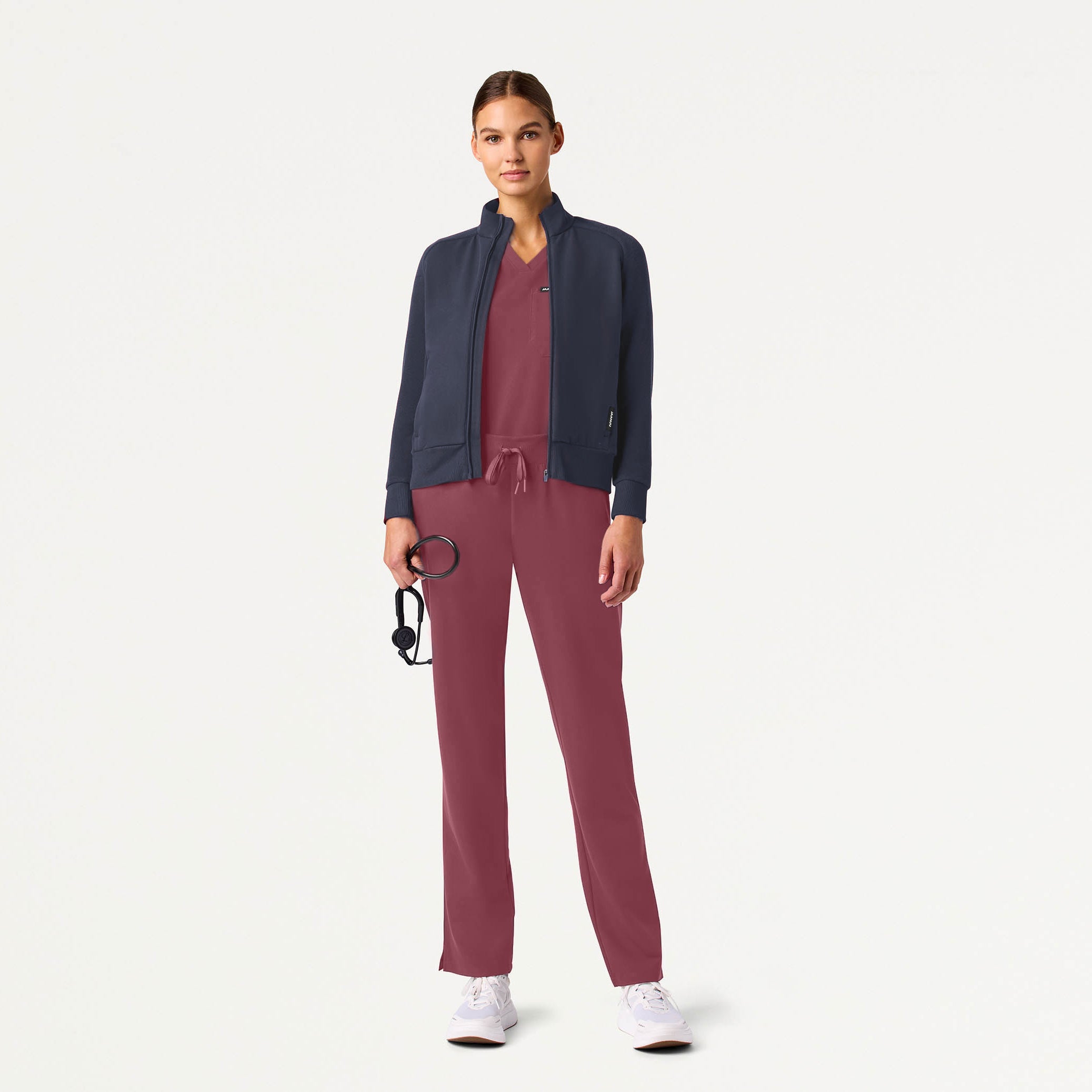 Woman wearing Rosewood scrubs with jacket