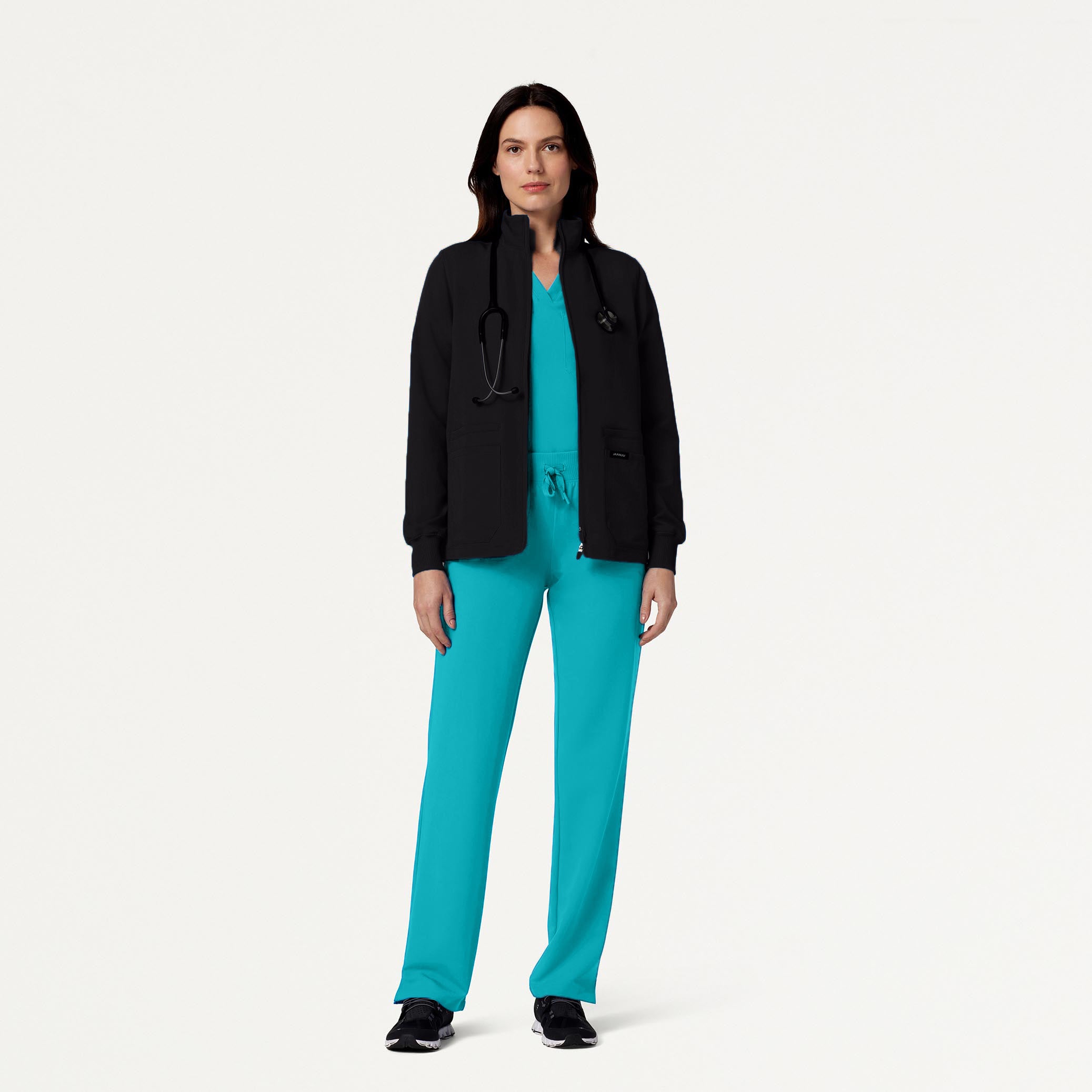 Woman wearing Teal scrub set with scrub jacket