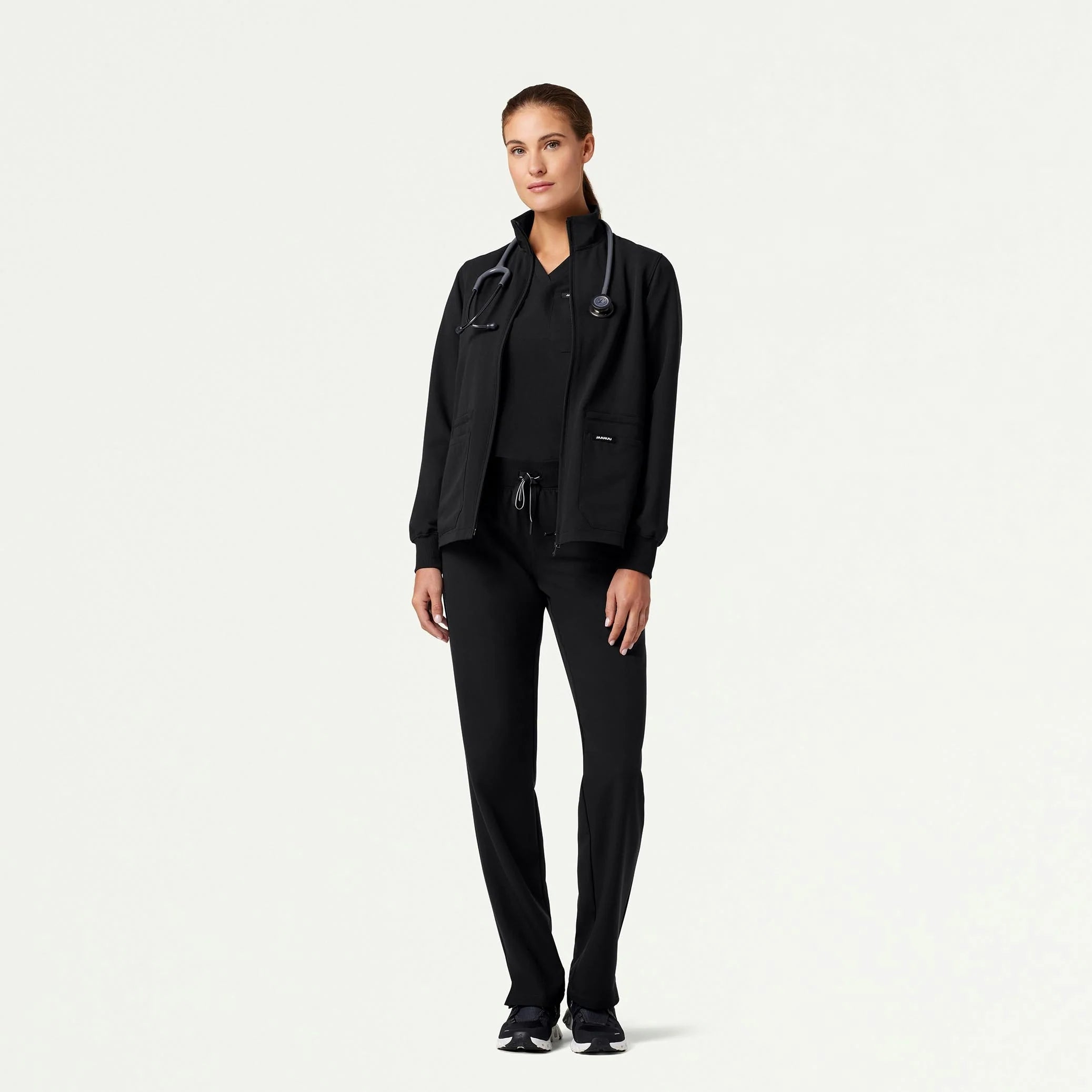 Woman wearing black scrub set with jacket