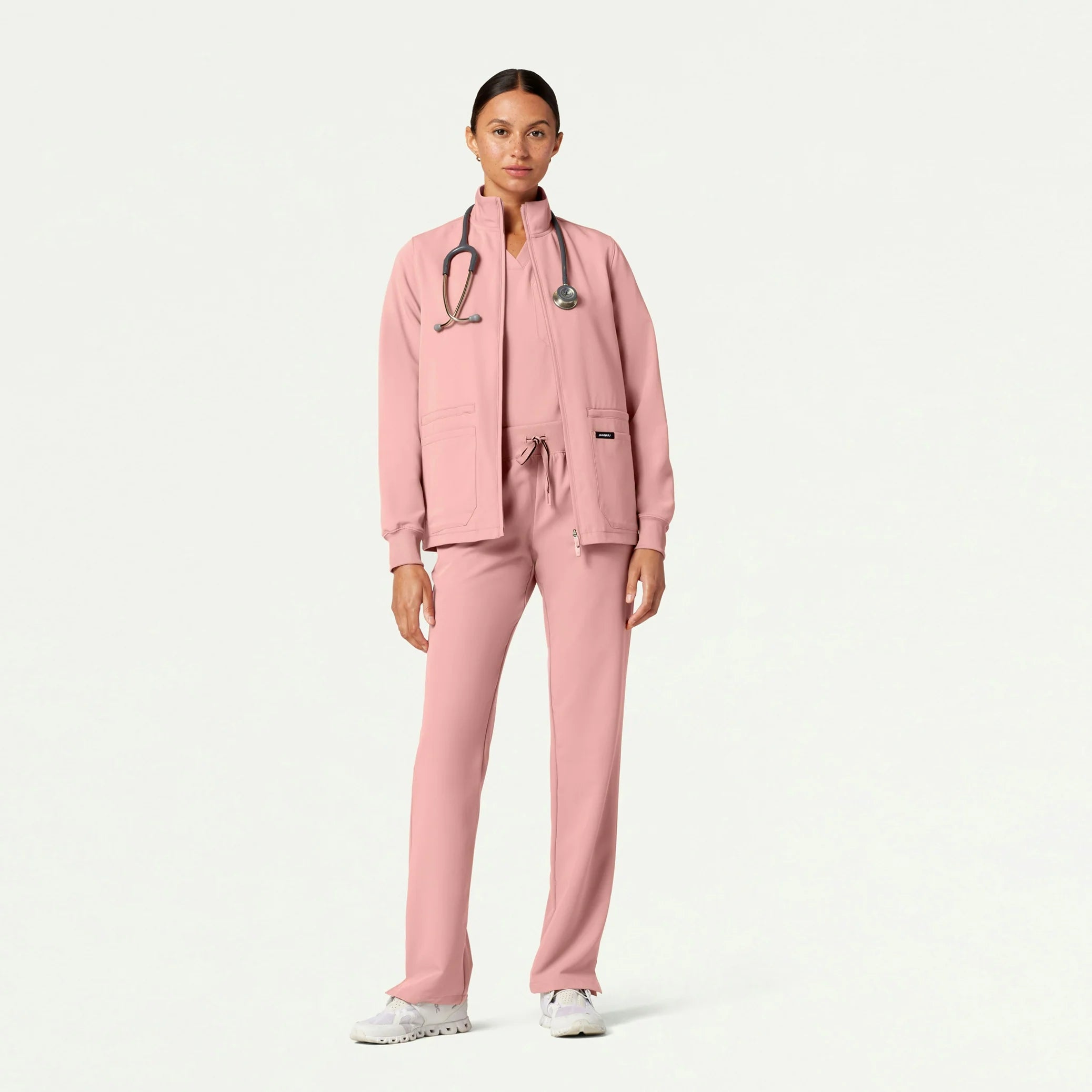 Woman wearing Mauve scrub set ith jacket