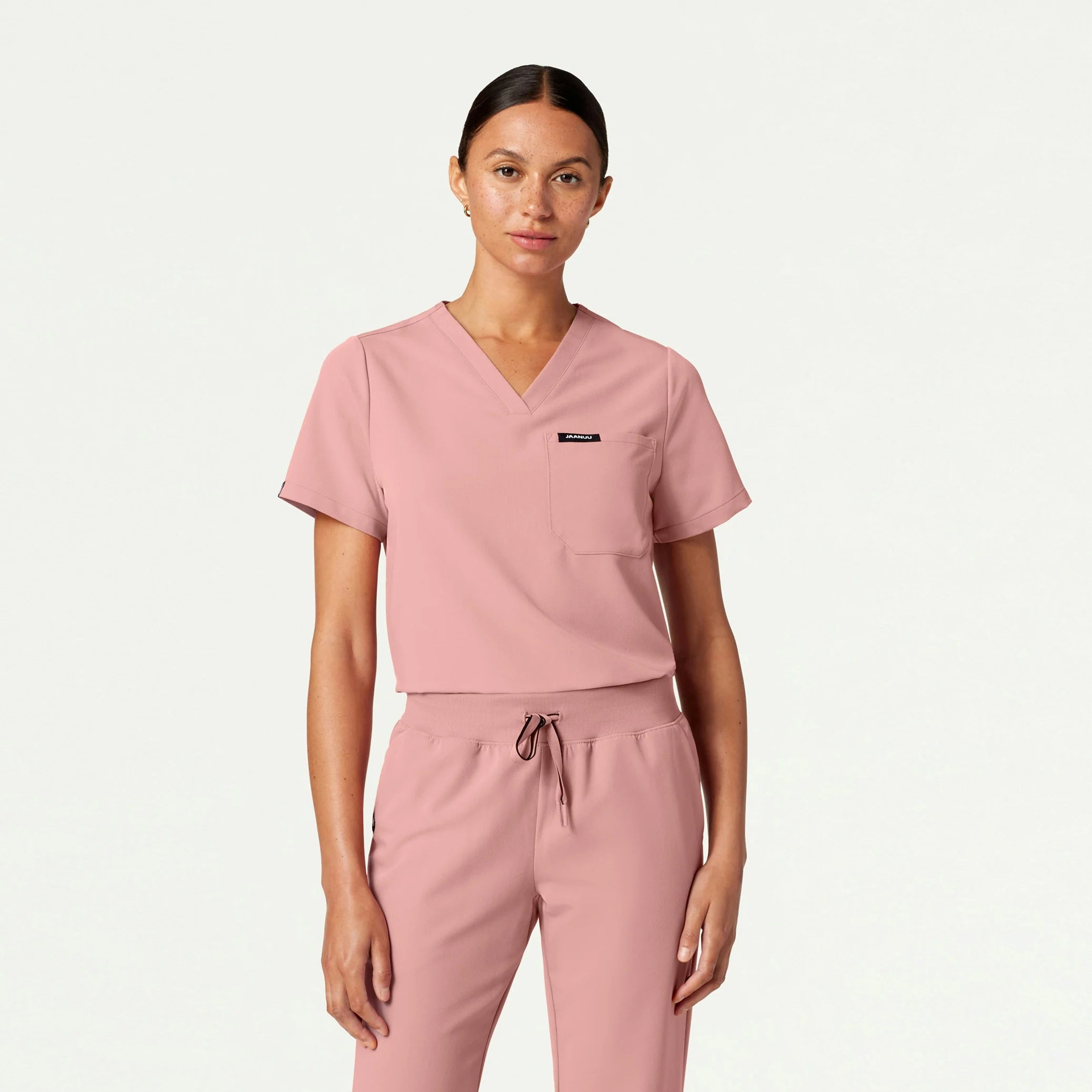 Woman wearing Mauve scrub top