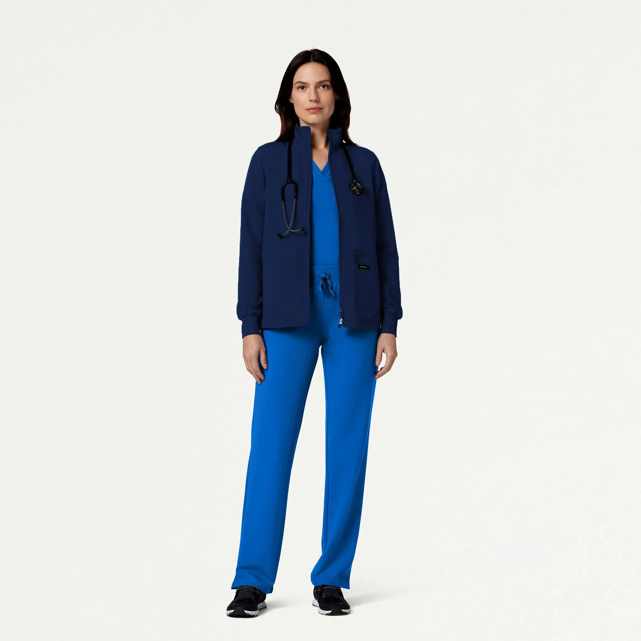 Woman in royal blue scrub set wearing scrub jacket