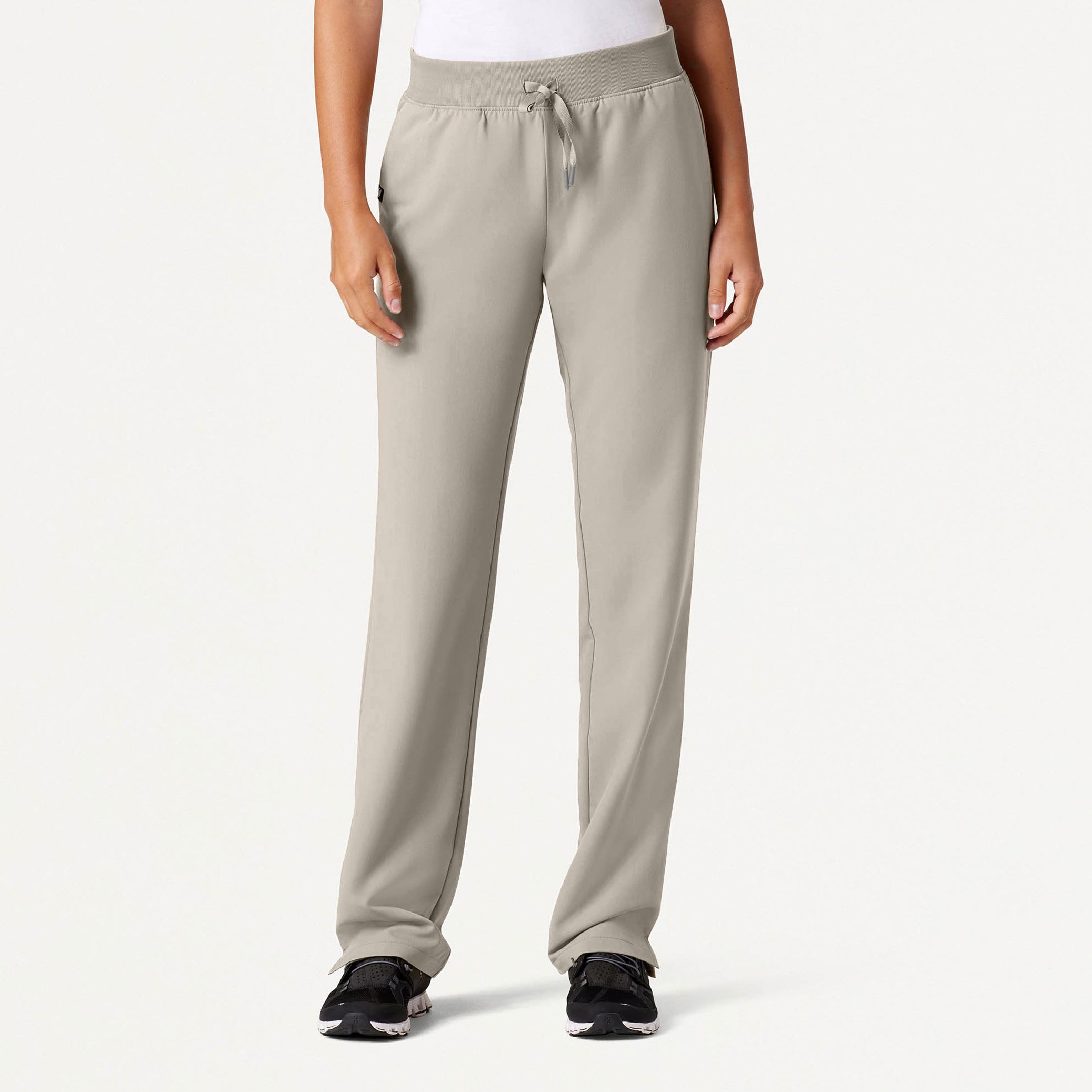 Beige sweatpants worn by a person on a white background