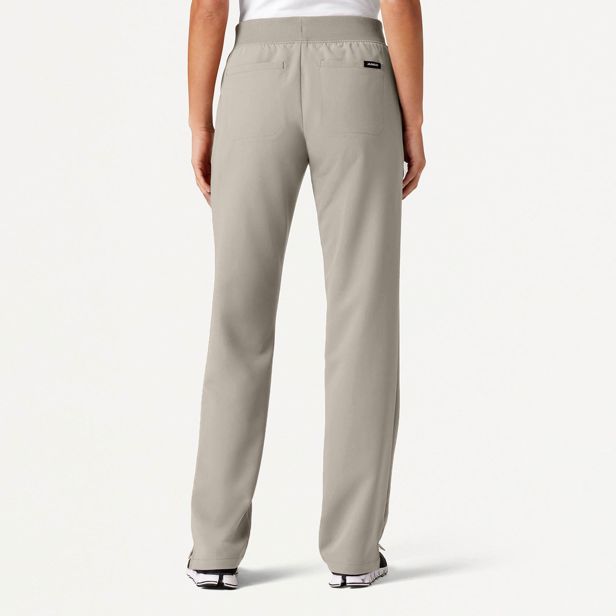 Beige pants worn by a person on a white background