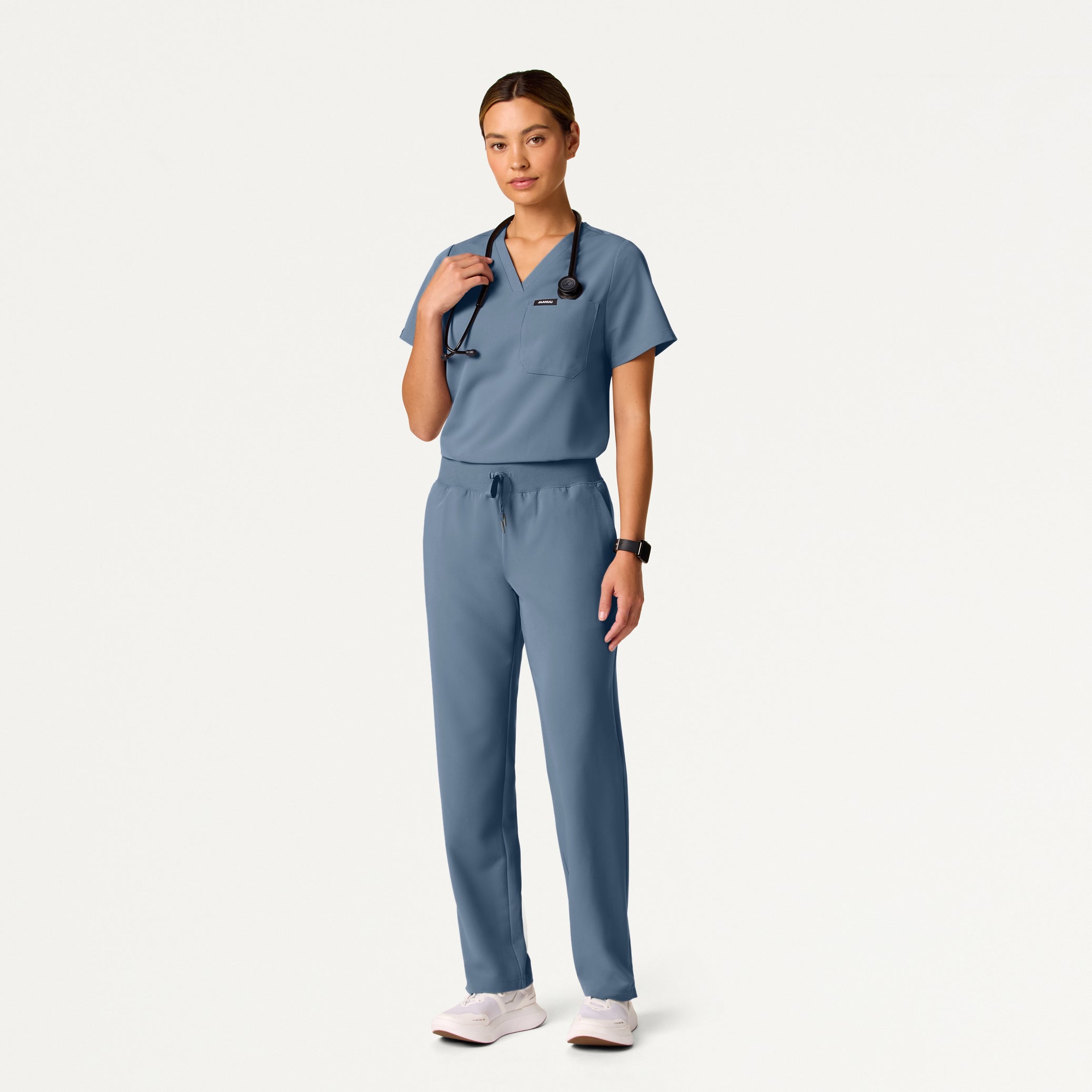 Person wearing a blue scrub set on a white background