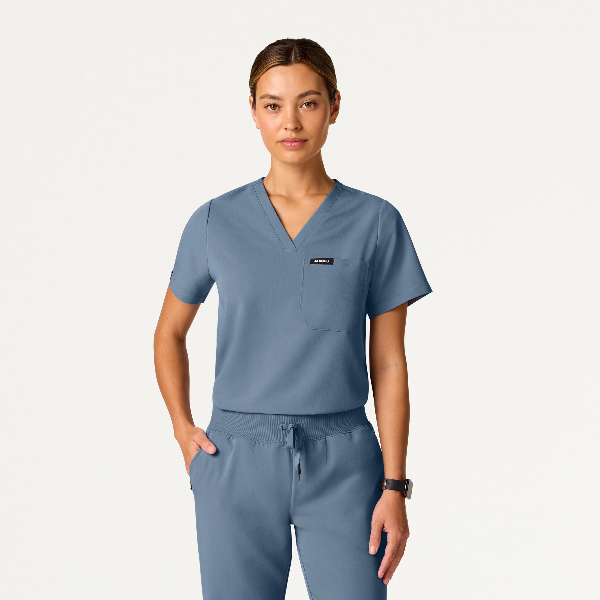 Person wearing a blue scrub set on a white background