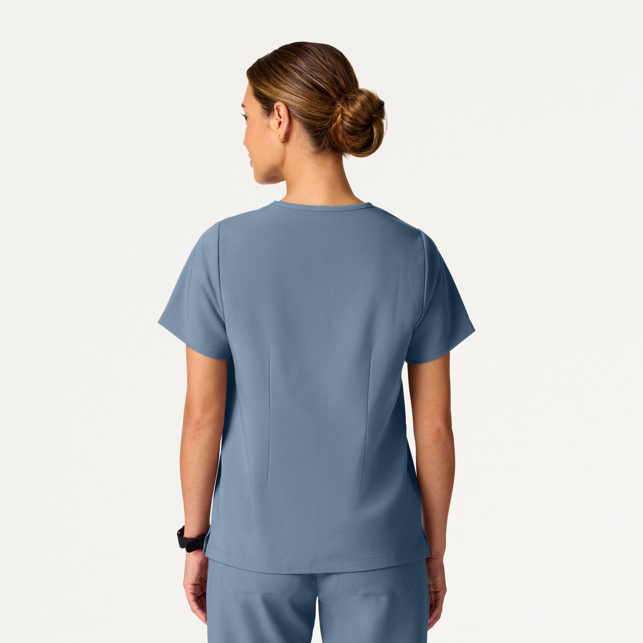 Person wearing a blue scrub set on a white background