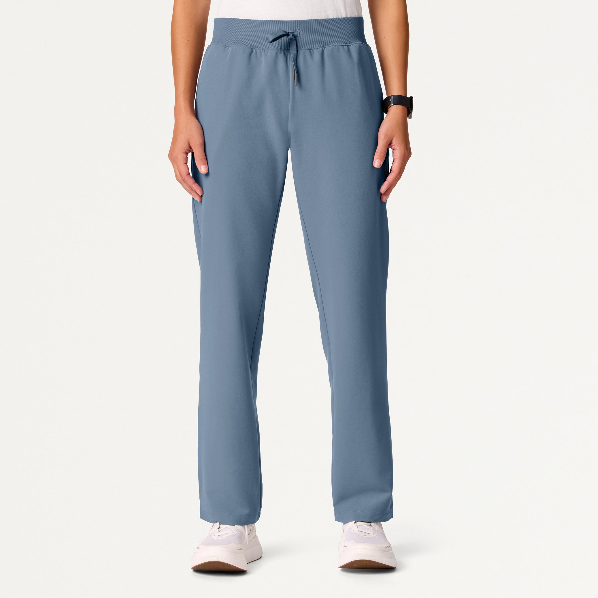 Person wearing blue pants on a white background