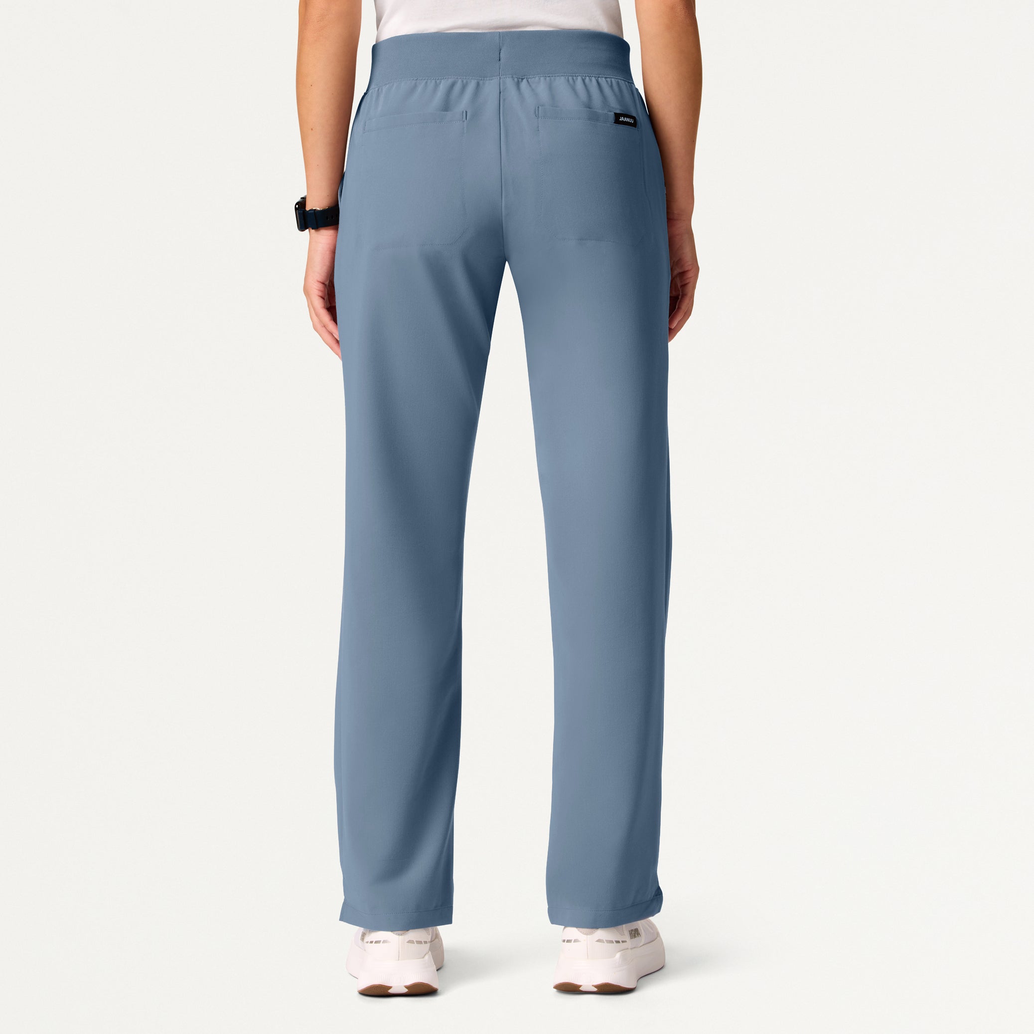 Blue pants worn by a person on a white background