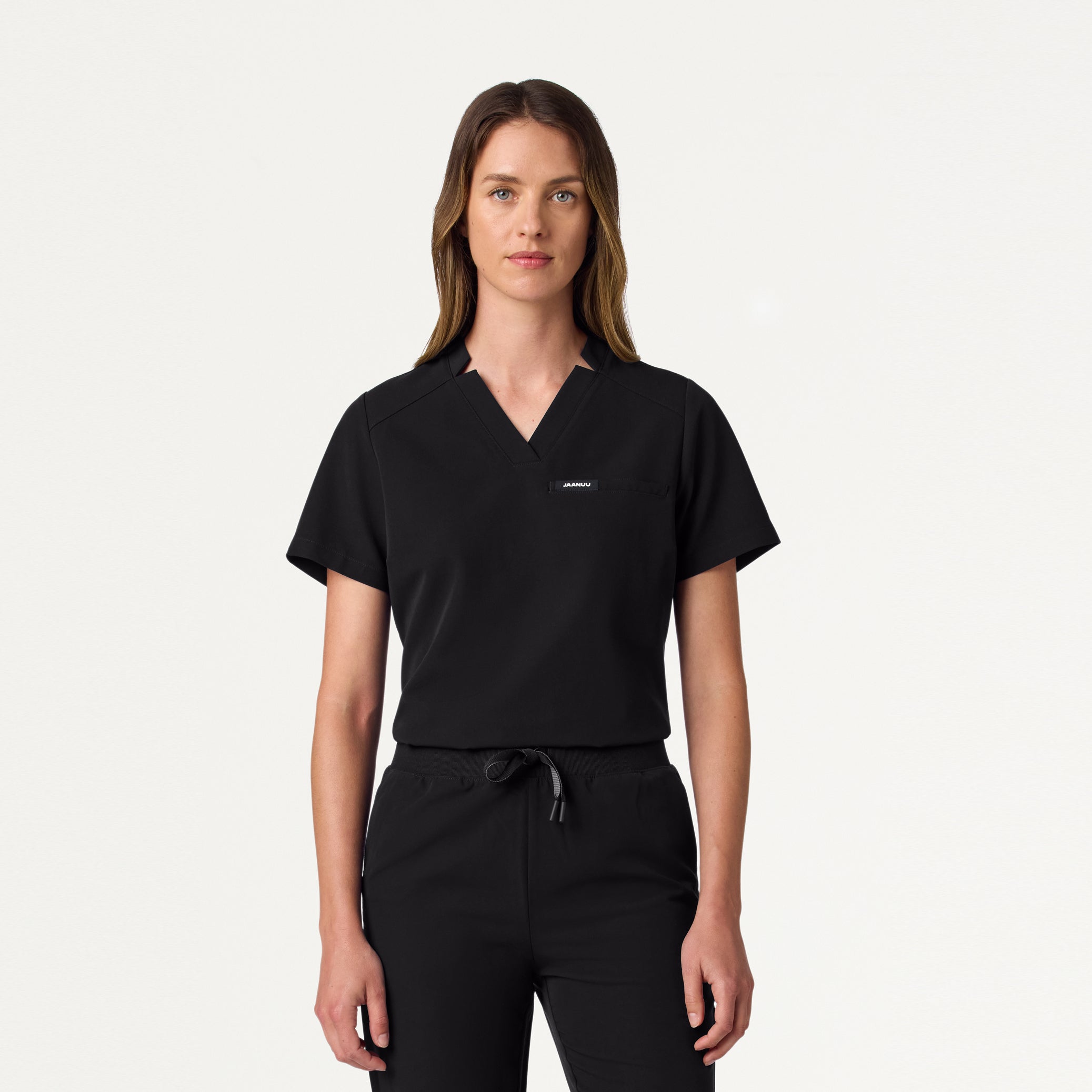 Woman wearing Black scrub top.