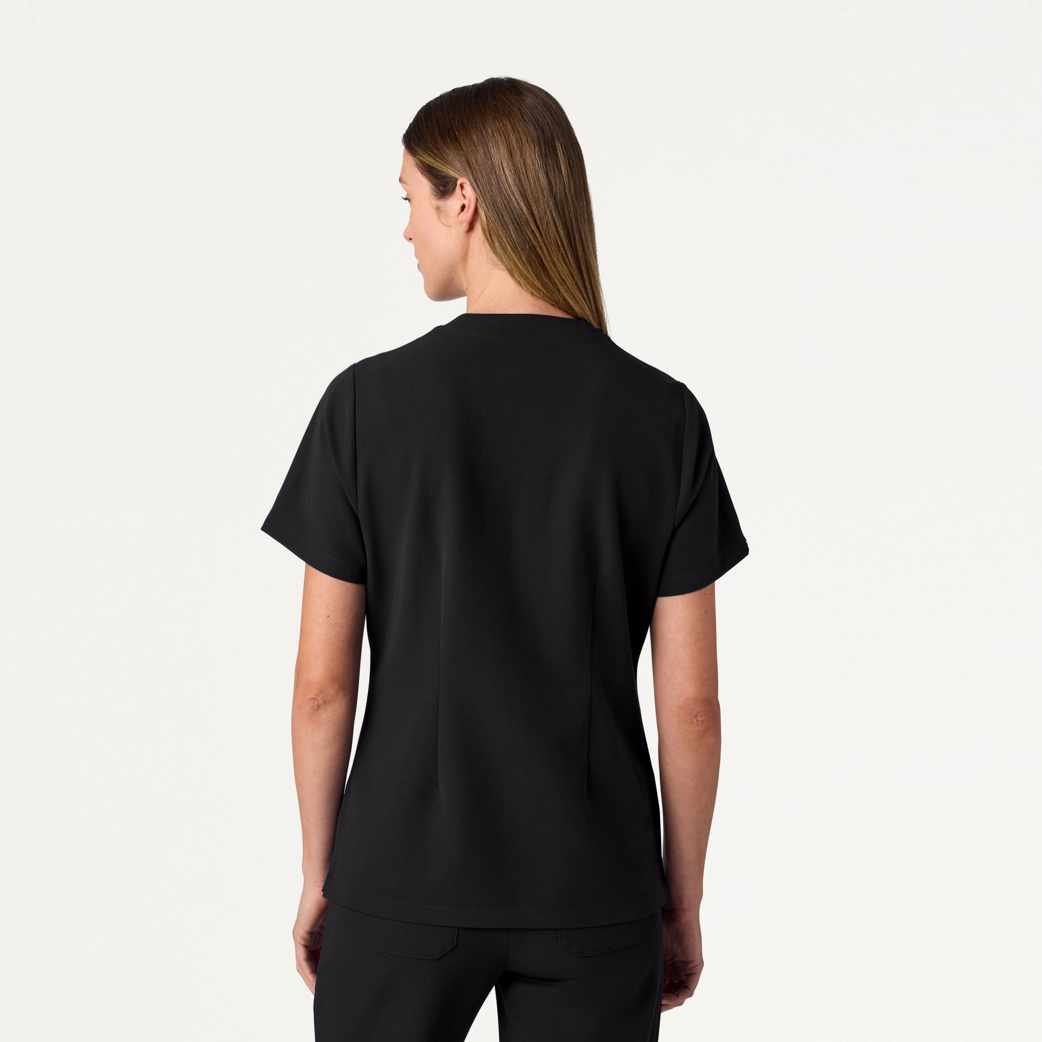 Woman wearing Black scrub top.