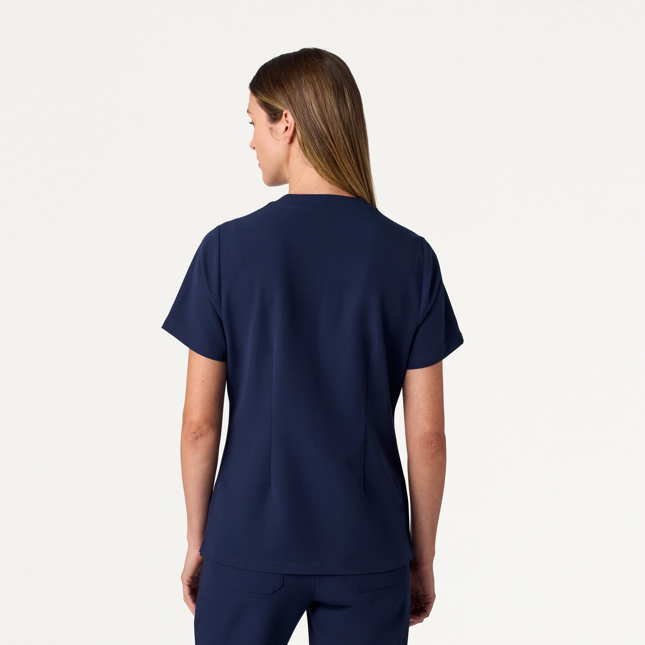 Woman wearing Midnight Navy scrub top.