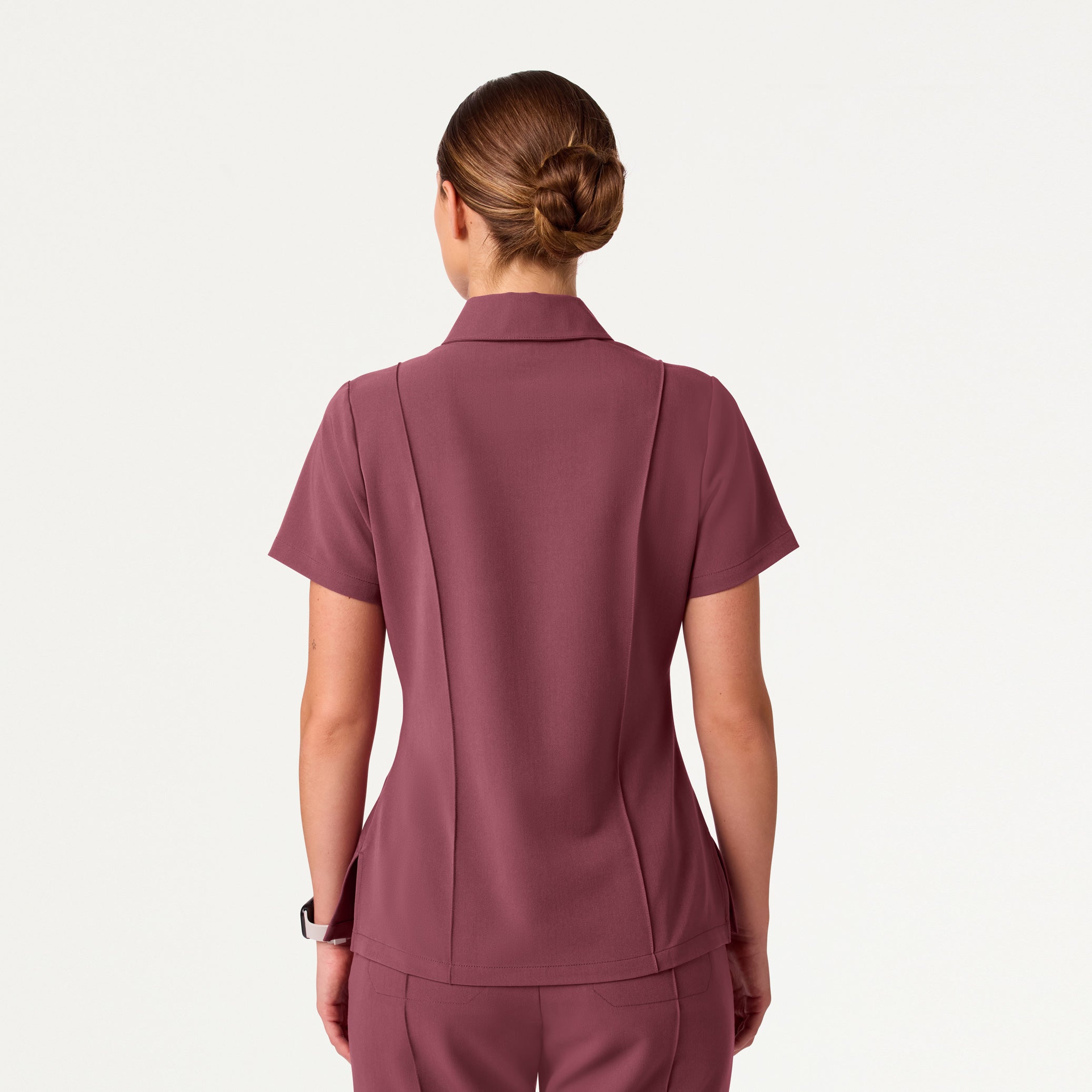 Woman wearing Rosewood scrub top