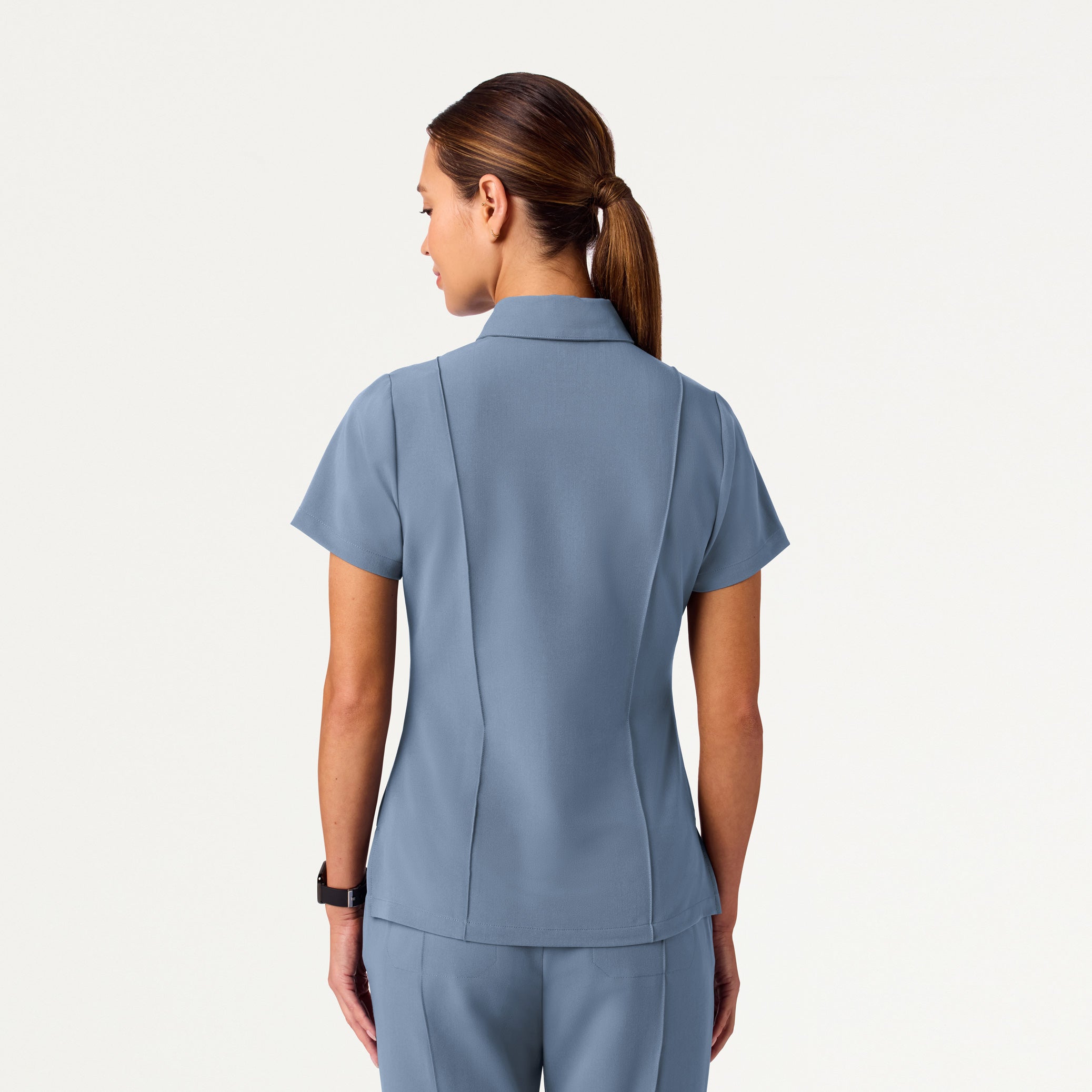 Woman wearing Storm Blue scrub top